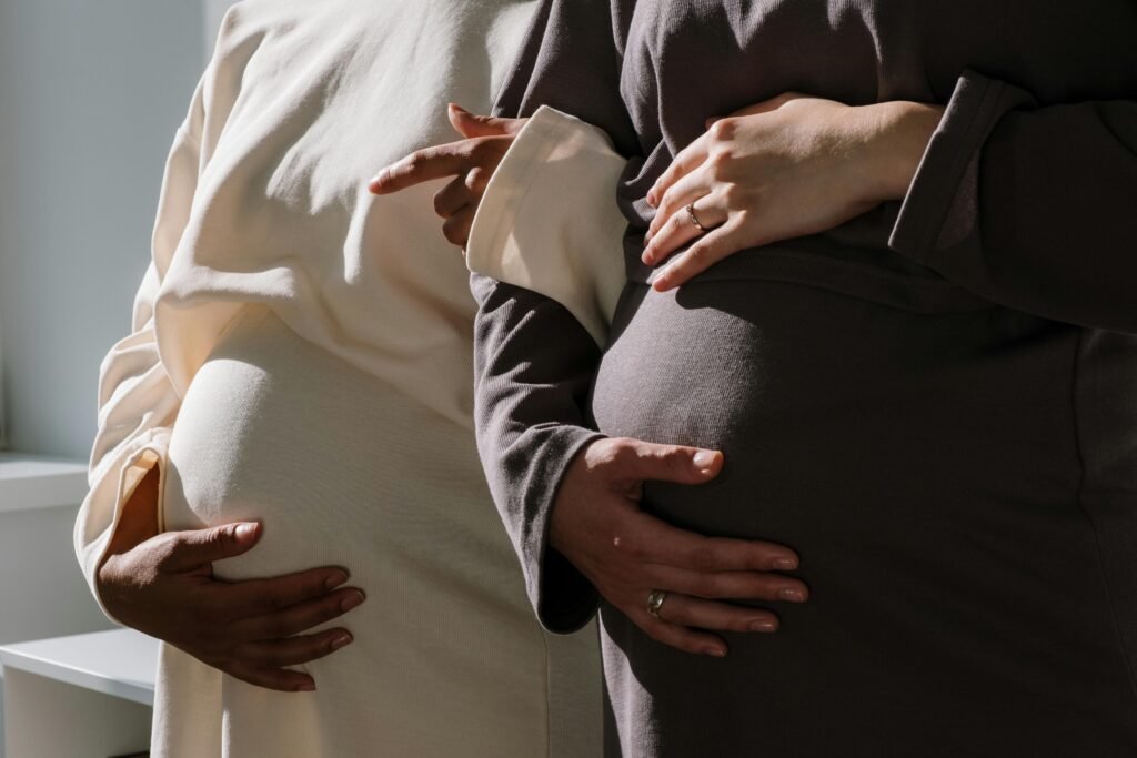 Close-up of two pregnant women embracing the beauty of motherhood.